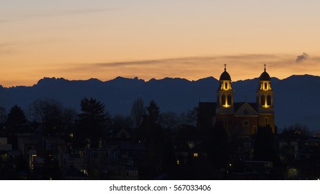 Sunset At Capitol Hill Neighborhood Of Seattle With Mountains In Background