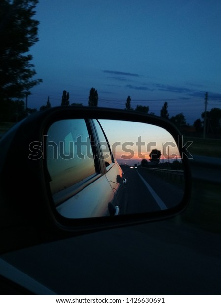sunset in the car mirror\
reflect