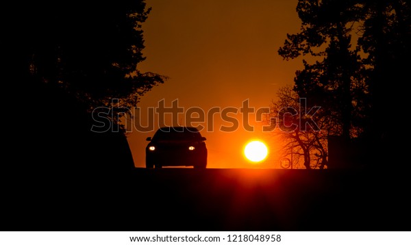 sunset car\
silhouette