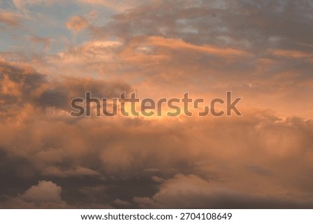 The sunset cast a beautiful, dramatic glow across the brooding, dark clouds.