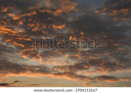 The sunset cast a beautiful, dramatic glow across the brooding, dark clouds.