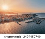 Sunset casts a warm light on a marina in Rethymno, Greece