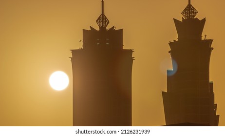 Sunset Cityscape Of Skyscrapers In Dubai Business Bay With Orange Sky Aerial Timelapse. Modern Skyline With Sun Behind Towers. A Center Of International Business