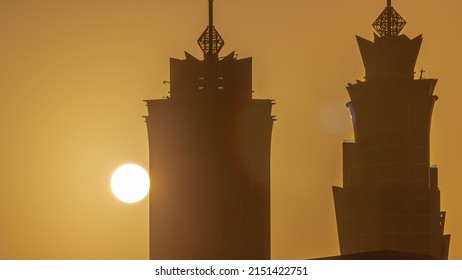 Sunset Cityscape Of Skyscrapers In Dubai Business Bay With Orange Sky Aerial Timelapse. Modern Skyline With Sun Behind Towers. A Center Of International Business