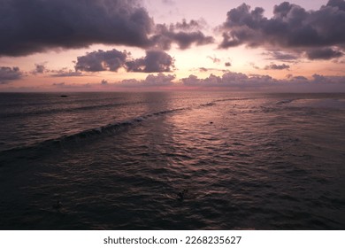 Sunset with clouds in the ocean with waves