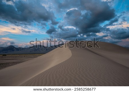 Sunset clouds over big dunes recreation area in Nevada 