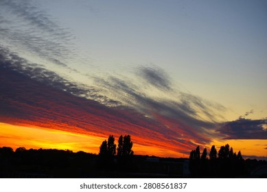 Sunset with clouds over the forest in summer