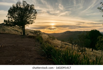 sunset with clouds over a hill