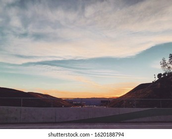 Sunset with clouds overlooking freeway. 