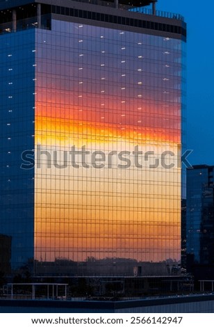 Sunset clouds reflected in glass windows on sixth and guadalupe st office and apartment building in Austin Texas