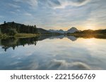 Sunset clouds reflected in still waters of the Snake River at Oxbow Bend, Grand Teton National Park, Wyoming.