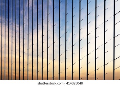 Sunset Clouds reflected in windows of modern office building
