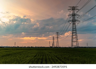 Sunset clouds and the silhouette of a power transmission tower - Powered by Shutterstock