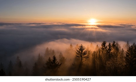 Sunset with clouds, sun rays, and misty valleys. - Powered by Shutterstock