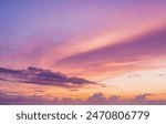 sunset cloudscape Panoramic with rich purple and pink tones blending into orange at horizon, tranquil evening sky view, natural dusk setting, soft wispy cloud formation, twilight backdrop