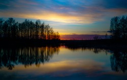 Sunset At Coast Of The Lake. Nature Landscape. Nature In Northern Europe. Reflection, Blue Sky And Yellow Sunlight. Landscape During Sunset.