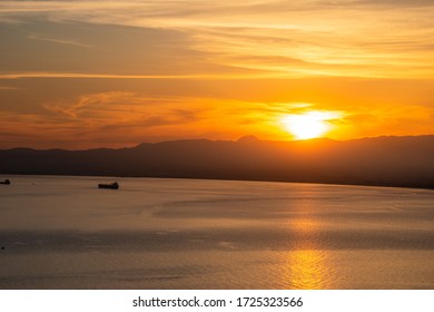 Sunset Colors With A Cargo Ship Travelling In The Messenian Gulf In Southern Greece