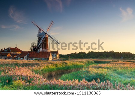 Sunset colours on Cley Windmill in the village of Cley, Norfolk, UK