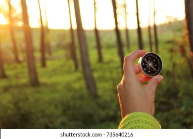Sunset and compass in hand.