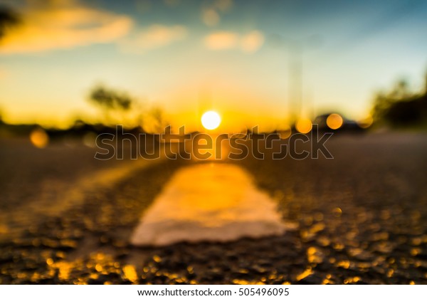 Sunset in the country, the car on the highway.\
Defocused image