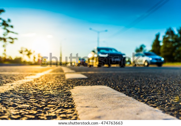 Sunset in the country, the stream of cars passing
by on the highway. Wide angle view of the level of the dividing
line, image in the blue
tones