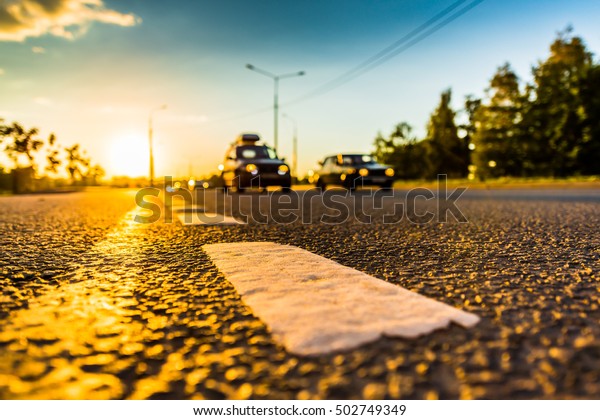 Sunset in
the country, the stream of cars passing by on the highway. Wide
angle view of the level of the dividing
line