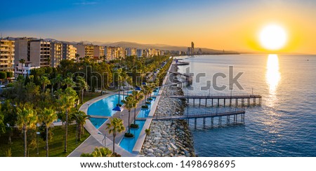 Sunset in Cyprus. The sun sets in the Mediterranean. Limassol at sunset. Evening panorama of Limassol with height. Mediterranean evening landscape. Holidays in Cyprus.