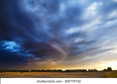 Sunset. Dark Clouds Coming From The South Announce The Weather Change, Possible Storm.