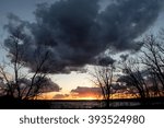 Sunset with dark clouds over the lake