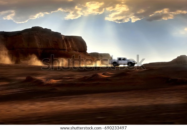 Sunset in desert. Beautiful rays of\
light and clouds. Iran. Kerman. Dasht-e Lut\
Desert.