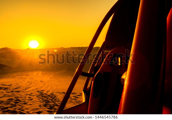 sunset in the\
desert with the silhouette of a\
car