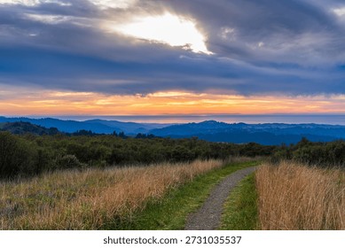 Sunset and dramatic afterglow over Bay Area ridge trail