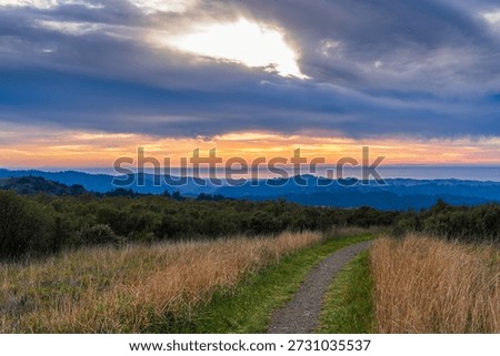 Sunset and dramatic afterglow over Bay Area ridge trail