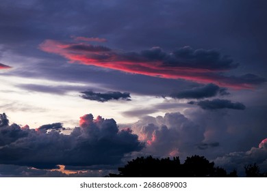 Sunset with dramatic sky. Cloudy sky at sunset. Real sky at sunset, with god rays and beautiful clouds.