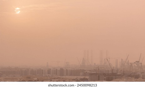 Sunset during sand storm over industry port in Dubai timelapse. Aerial view from above at foggy weather with orange sky - Powered by Shutterstock