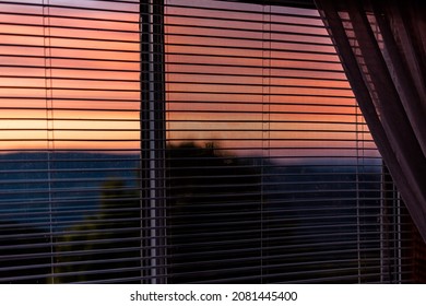 Sunset Dusk Twilight In Sugar Mountain House Apartment With View Through Window Blinds And Vibrant Red Orange Color Sky In North Carolina Blue Ridge Appalachias