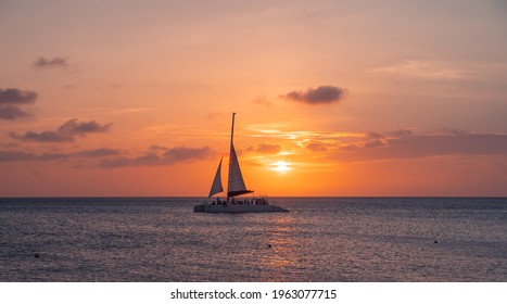 sunset at eagle beach in aruba in the caribbean with catamaran in composition - Powered by Shutterstock