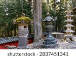Sunset. The even rows of stone lanterns - sculptures. Japan. Nikko Tosho-gu is  Shinto shrine in Nikko. Built in 1617. Majestic pine forest and ancient temple. 