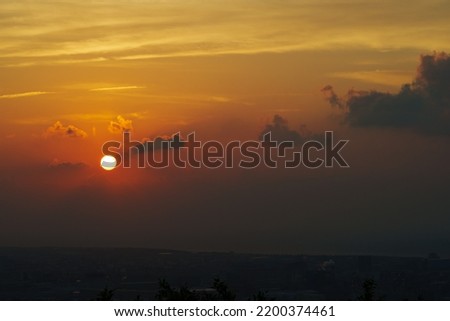 The sunset fade away behind the clouds