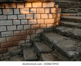 Sunset Glow on Alley Street: Concrete Staircase and Cobblestone Wall. - Powered by Shutterstock