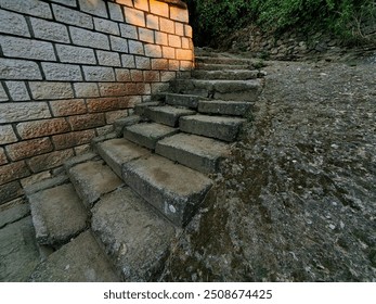 Sunset Glow on Alley Street: Concrete Staircase and Cobblestone Wall. - Powered by Shutterstock