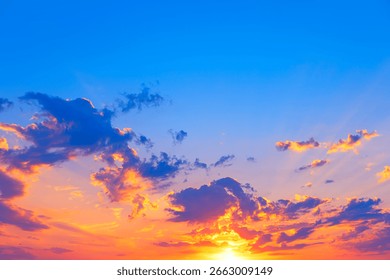 Sunset glows as sun dips below the horizon. Scattered clouds catch the light, adding depth to the tranquil gradient sky. Dramatic sunset colors reflected in vast expanse of sky