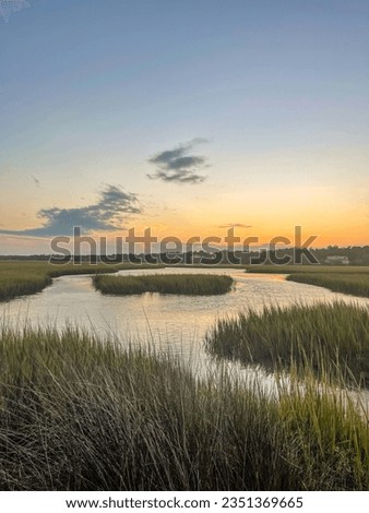 Sunset and golden hour light over The Salt water marsh and the sound behind Pawley's Island, South Carolina