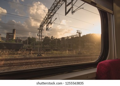 Sunset, golden hour view of train tracks and railroads from the inside of the train window.
 - Shutterstock ID 1255563835