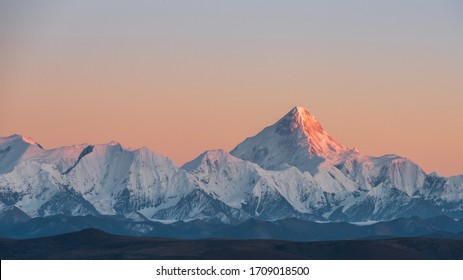 At sunset, the golden sun shines on Gongga Snow Mountain - Powered by Shutterstock