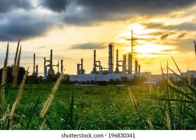 Sunset Green Grass Field And Oil Refinery Backgrounds