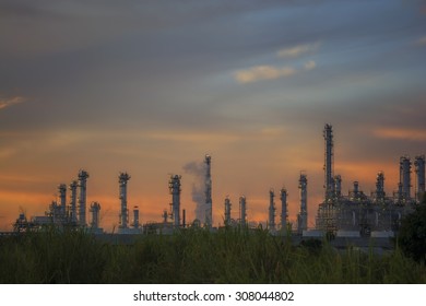 Sunset Green Grass Field And Oil Refinery Backgrounds