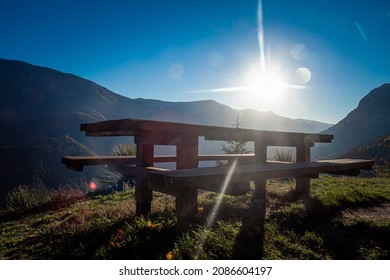 Sunset happy hour at epic picnic table and bench on mountain side paradise