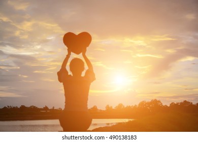 sunset in heart hands
