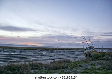 Sunset at Heswall boat yard Wirrl UK - old wrecks decay on the shoreline of the Dee estuary